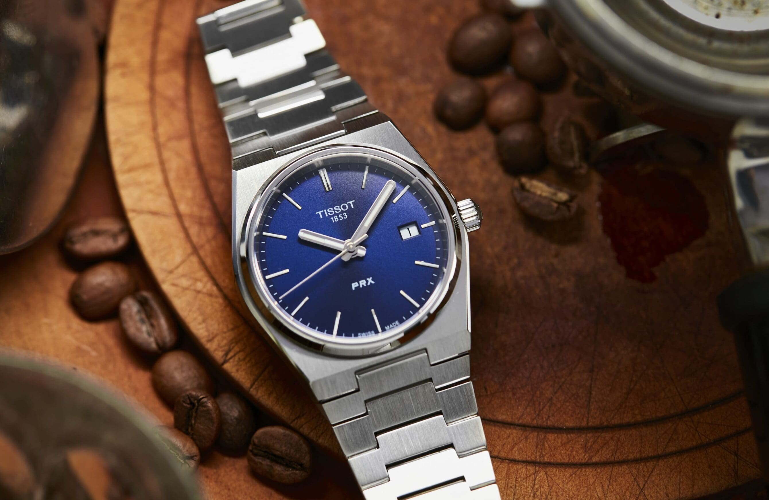 Silver Tissot PRX with blue dial.