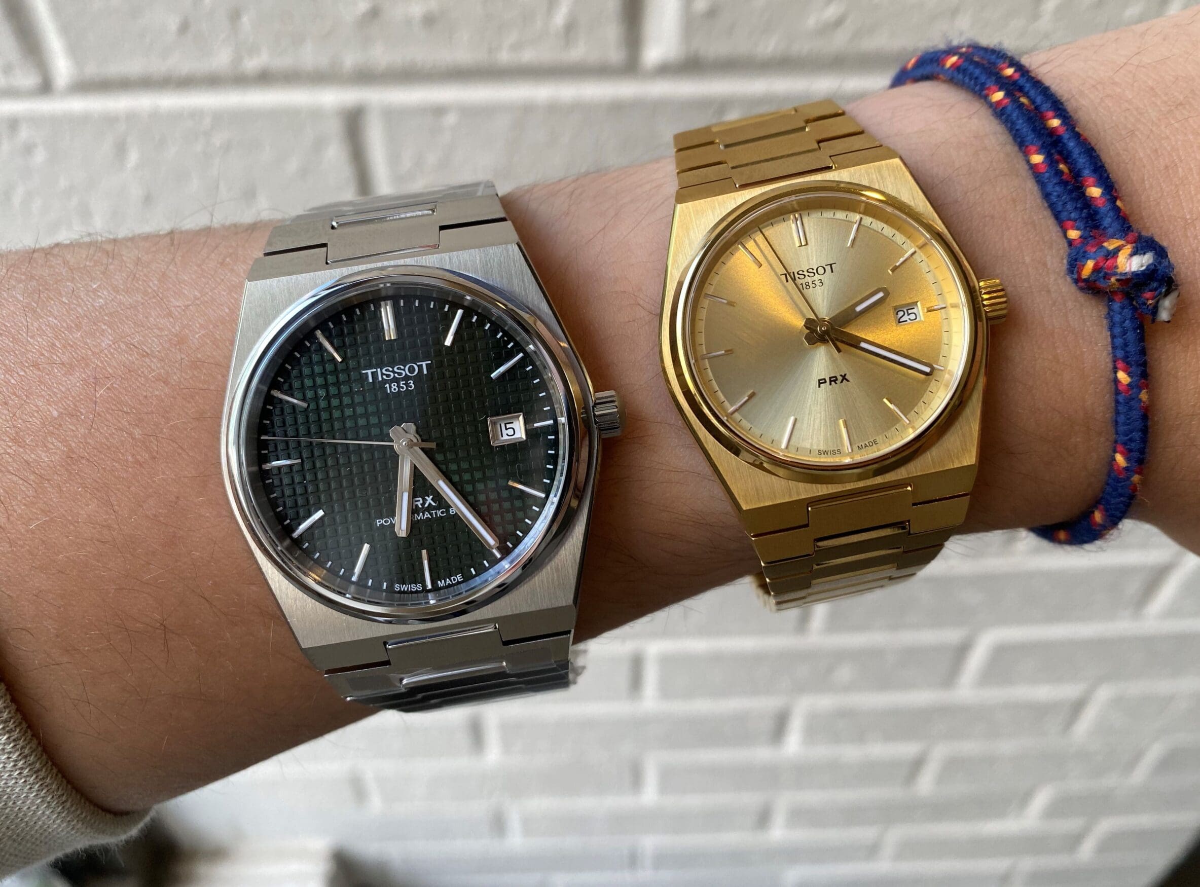 Tissot PRX watches in silver and PVD gold on wrist.