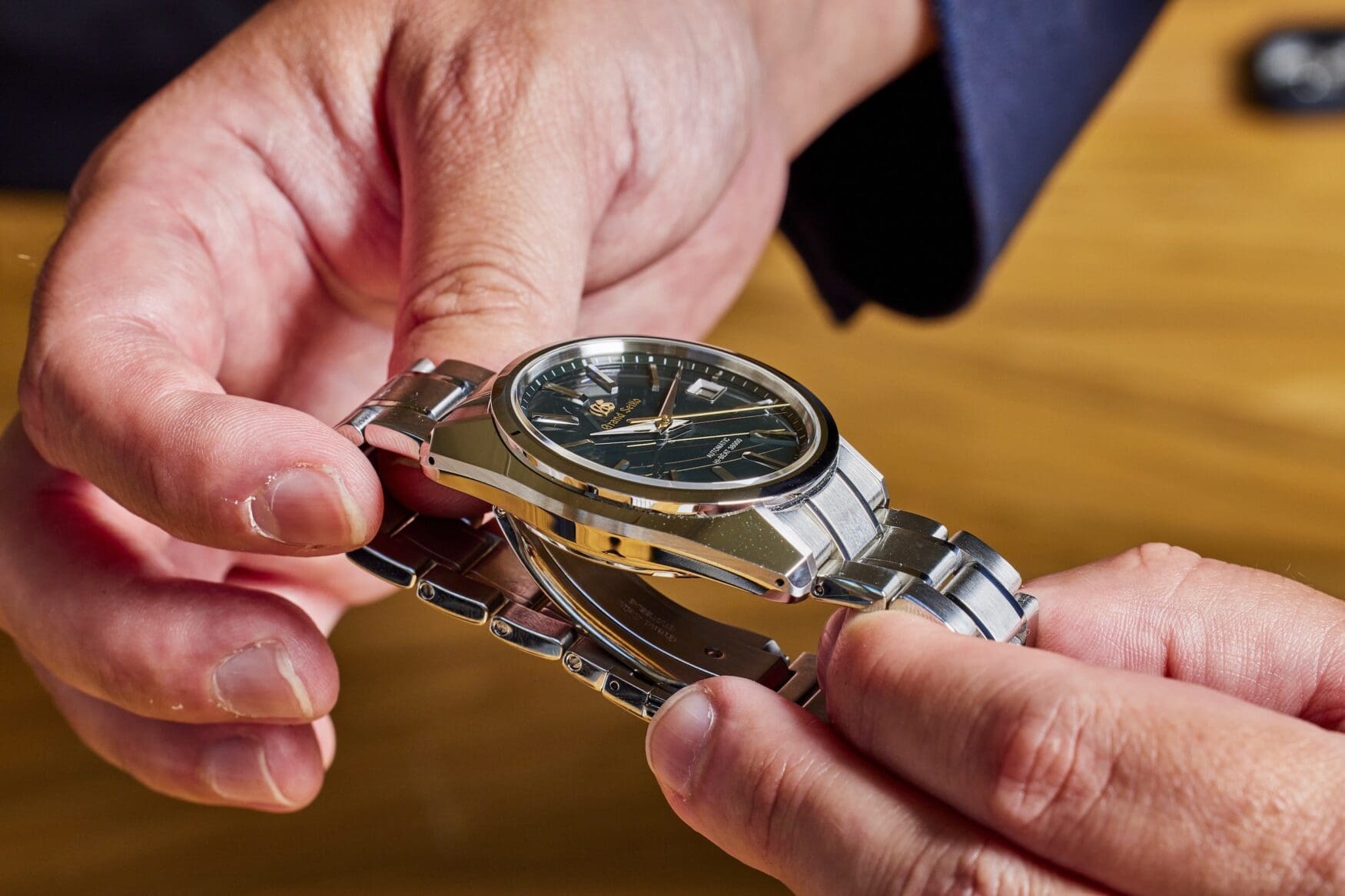 Grand Seiko SBGH283 held with both hands