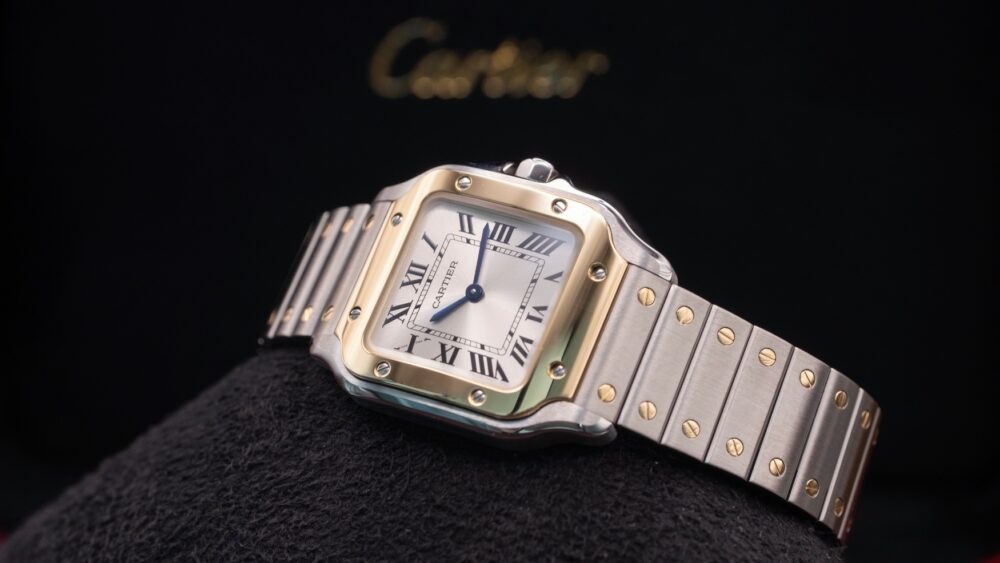 The itty bitty Santos de Cartier still delivers oodles of two-tone charm